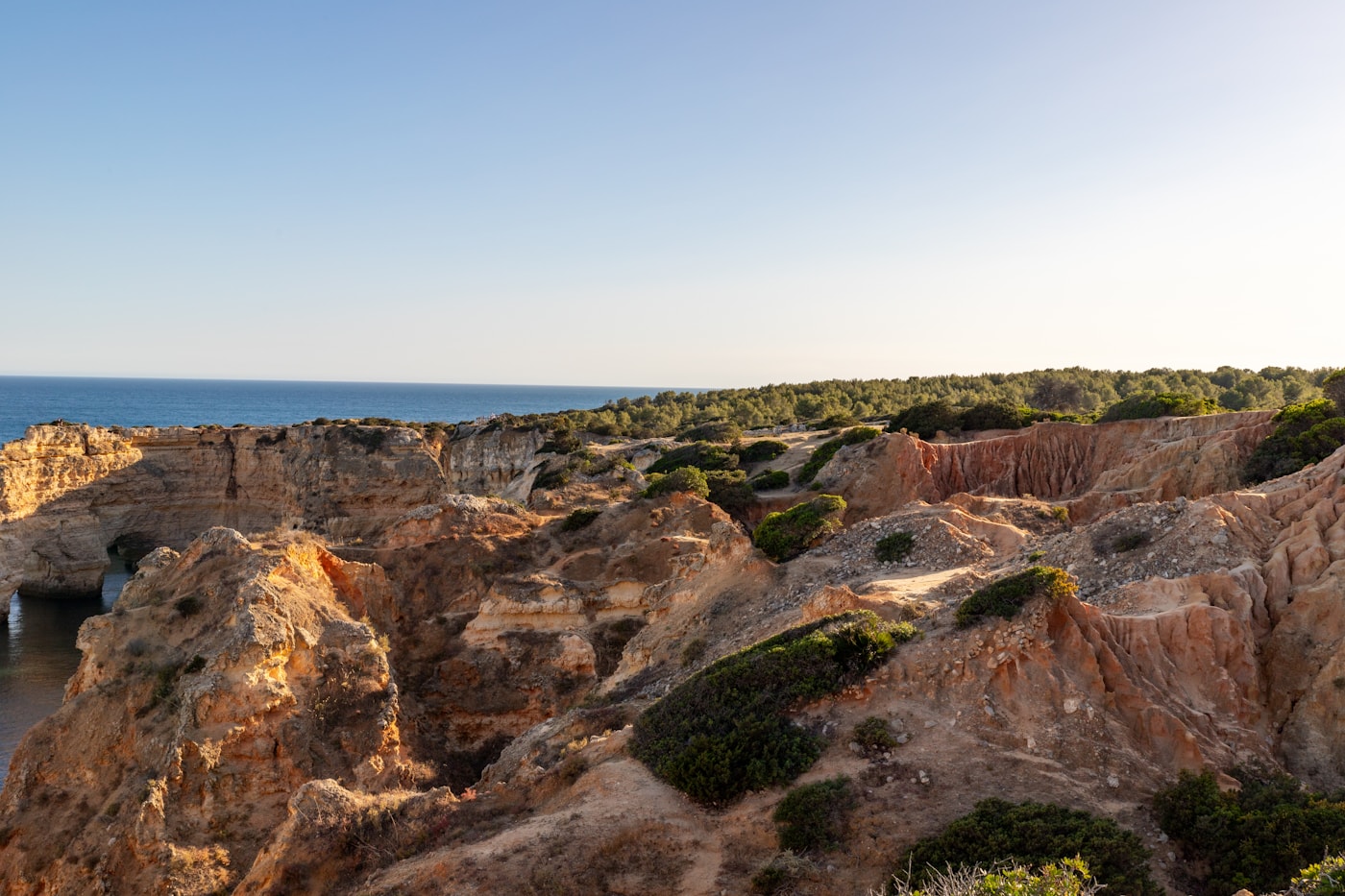 Dramatic golden limestone cliffs overlooking the Atlantic Ocean, Algarve, Portugal